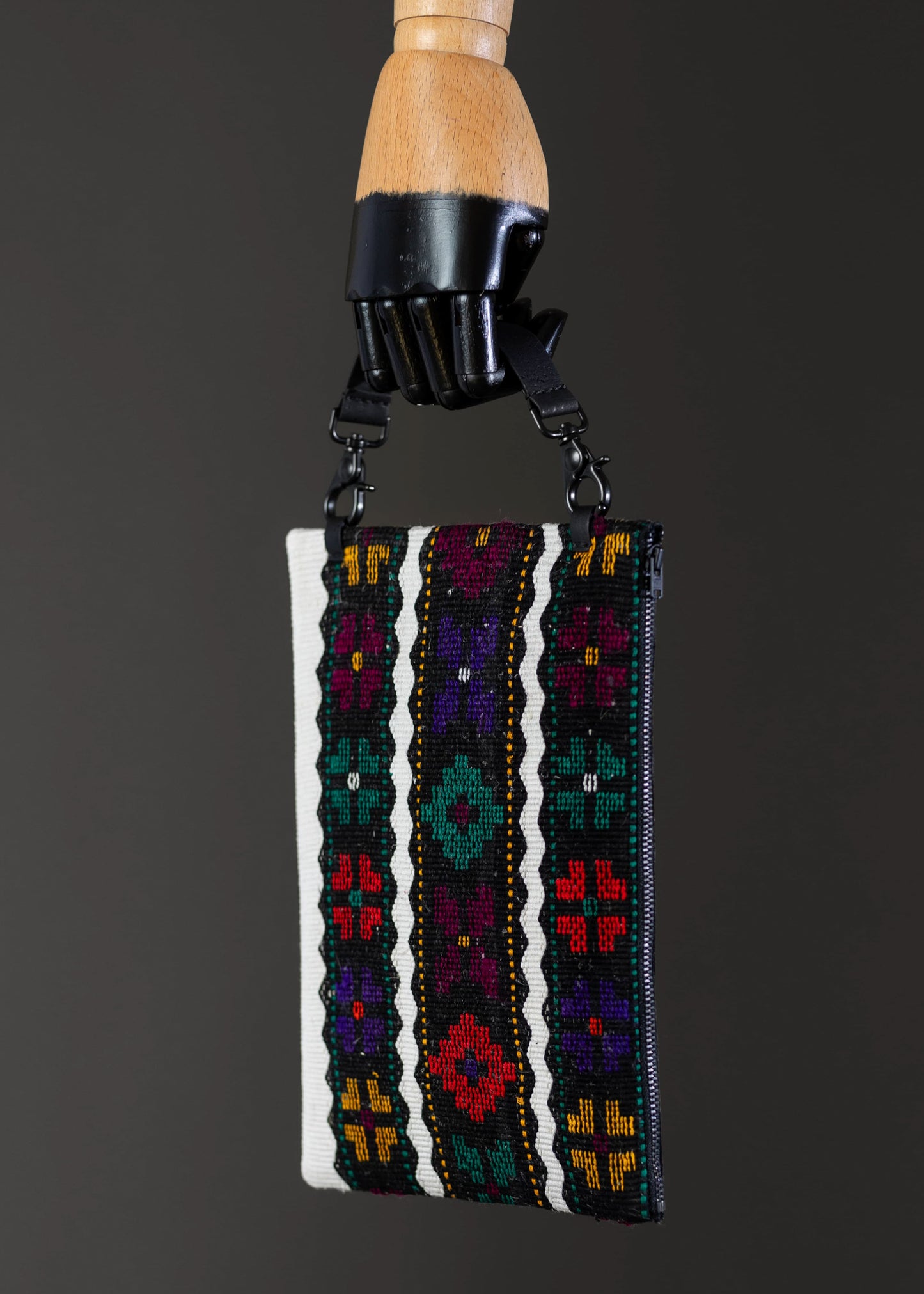 Side view of FTLO bag featuring a vibrant floral embroidery on a striped backdrop.