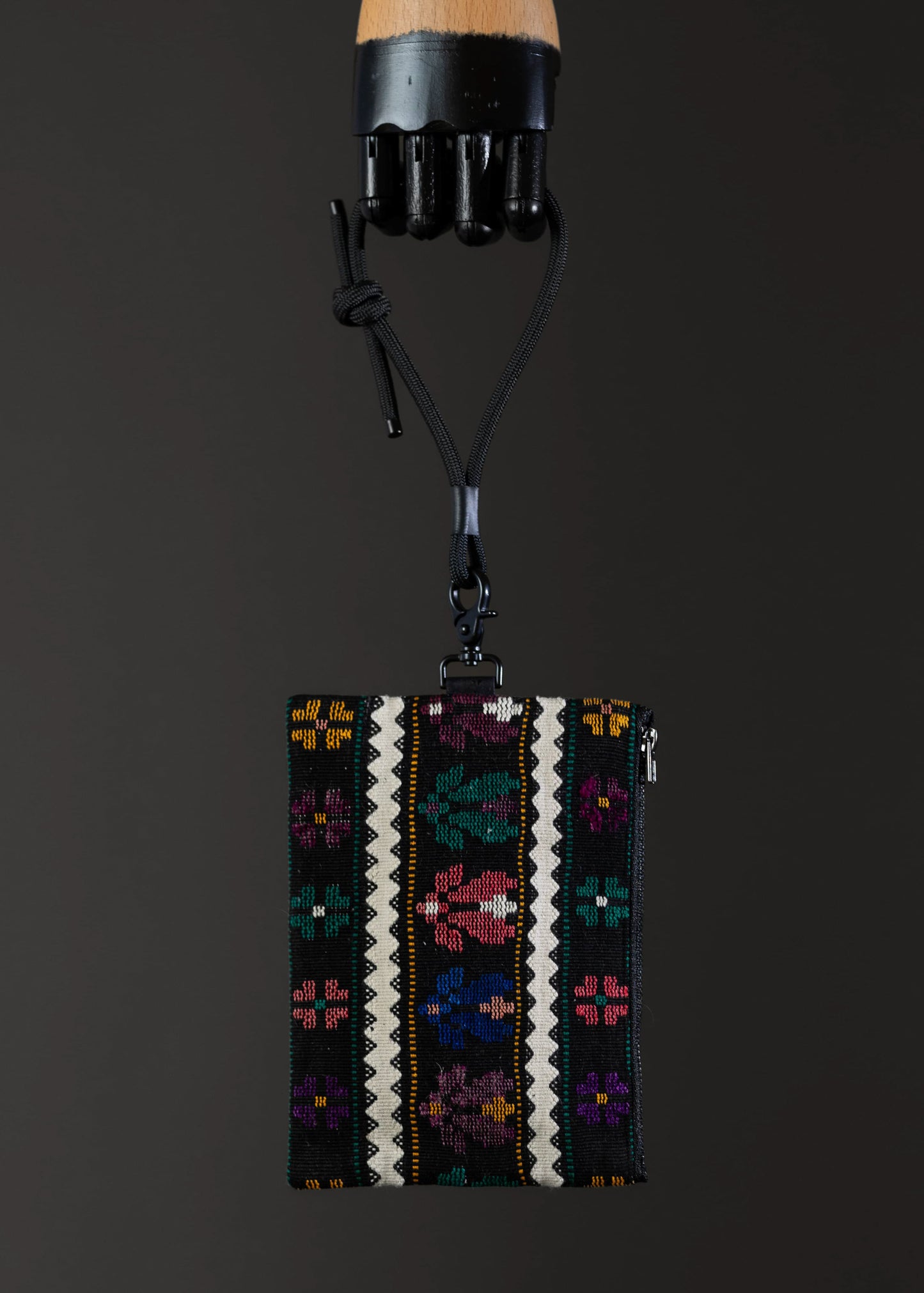 Front view of FTLO bag with a vivid abstract floral pattern on a black background.