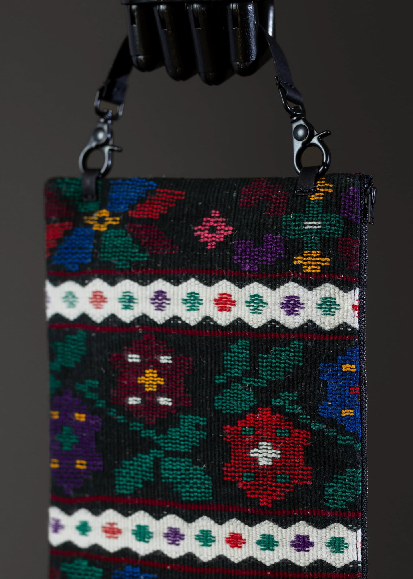 Motif detail of FTLO multicolor floral woven clutch displaying vibrant colors.