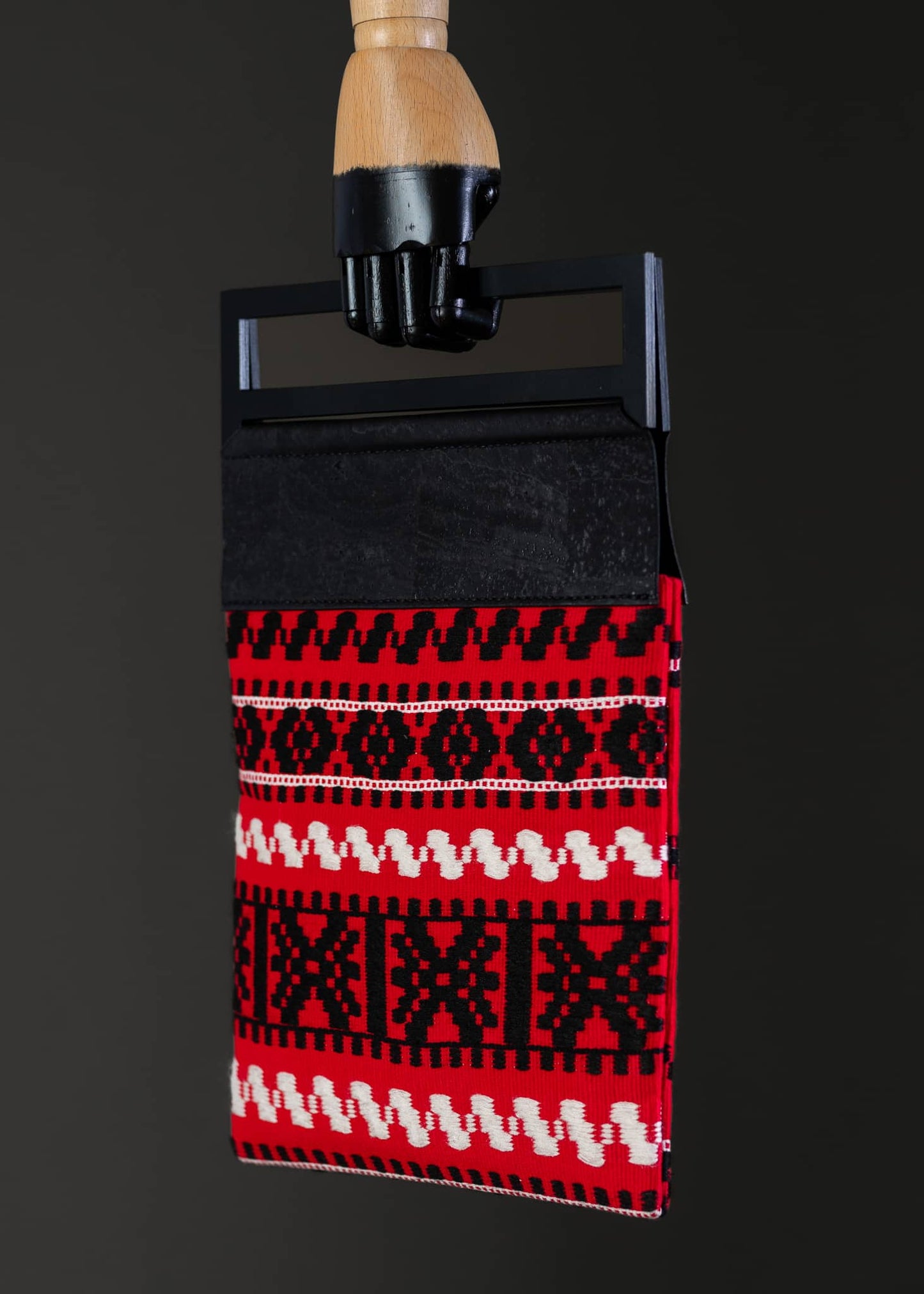 Side angle of FTLO bag highlighting the contrast between the red background and the black seam.