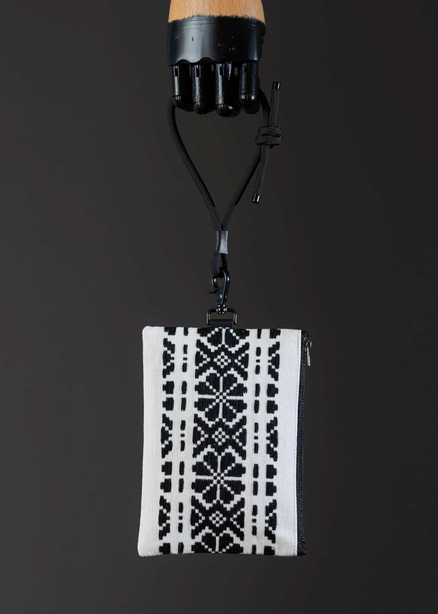 Front view of FTLO black and white geometric patterned bag.