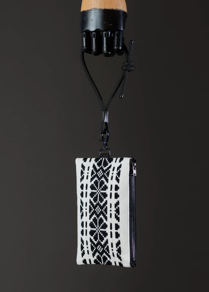 Side view of FTLO black and white geometric patterned bag showing pattern continuity.