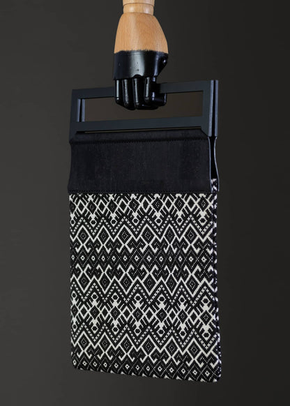 Side view of FTLO black and white geometric bag, highlighting the sleek edges and pattern continuity.