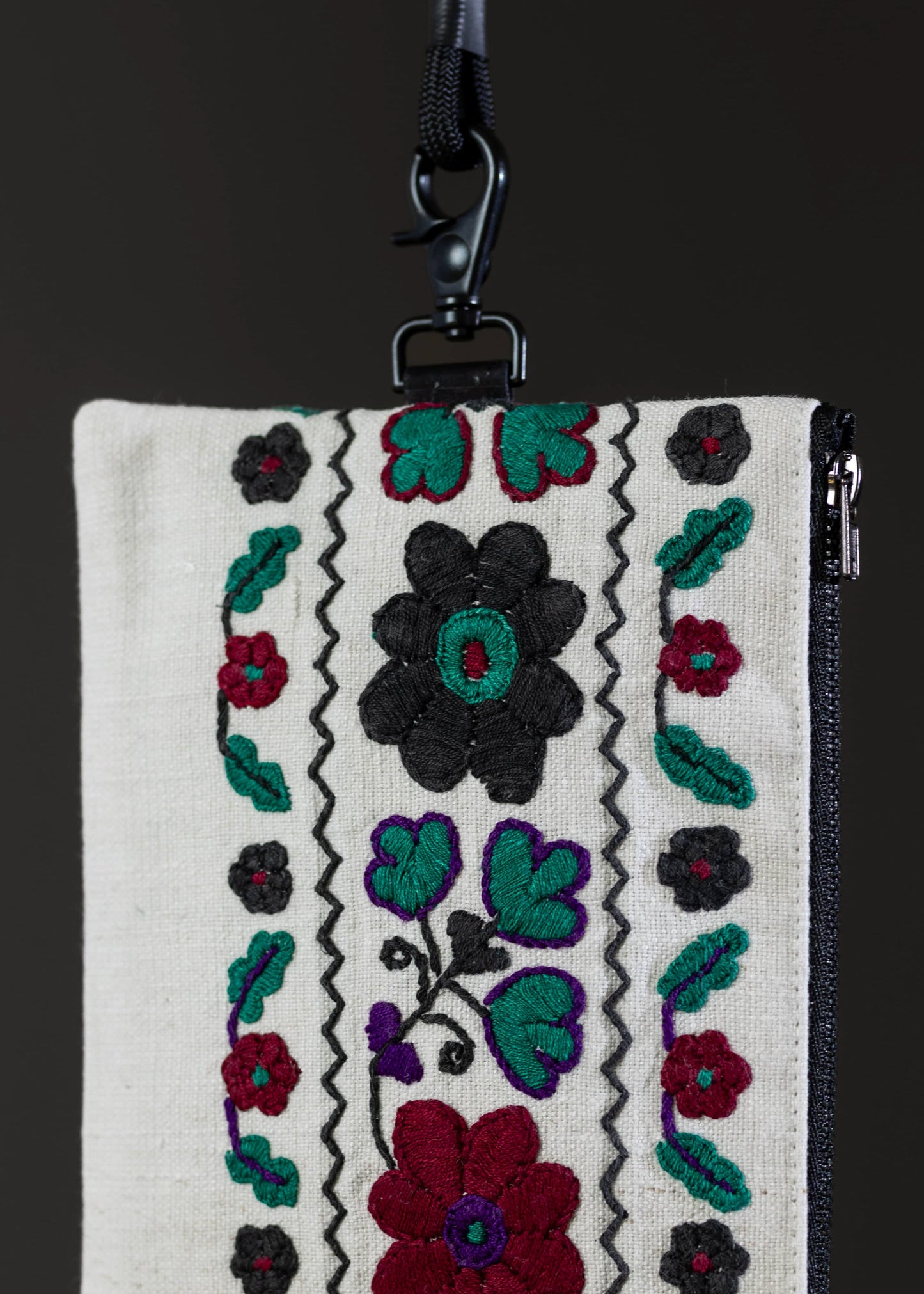 Close-up of the FTLO bag's woven motif, displaying a tapestry of garden blooms and foliage.