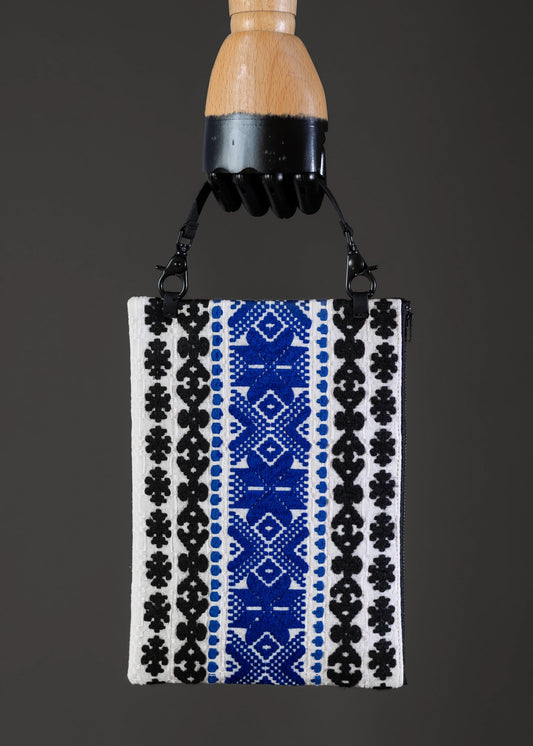 Front view of FTLO bag featuring blue and black vintage Romanian handwoven motifs.