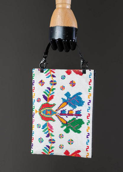 Front view of FTLO clutch with vibrant, multicolored Romanian embroidery