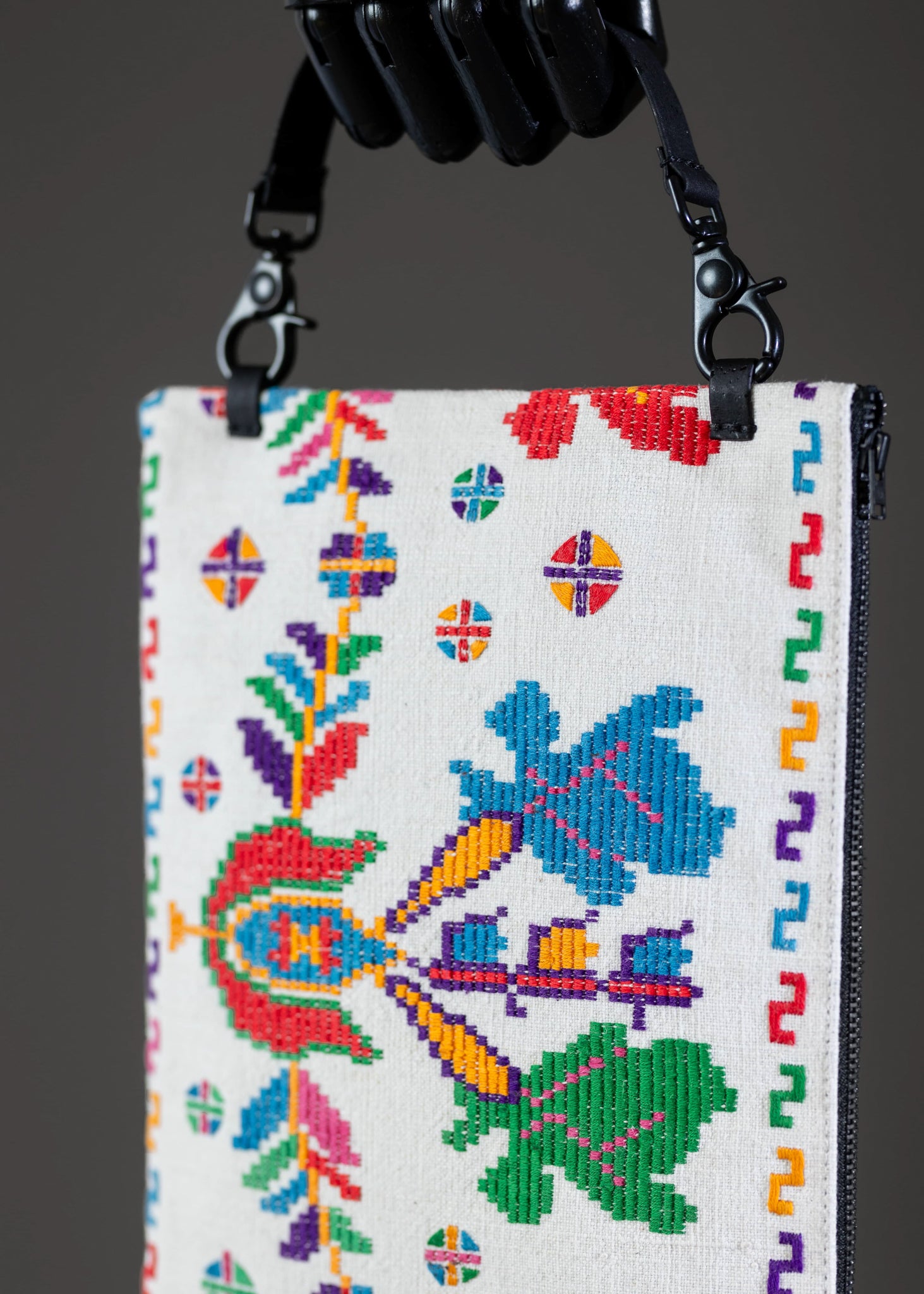 Close-up of the traditional motif on FTLO's handwoven colorful embroidered clutch.