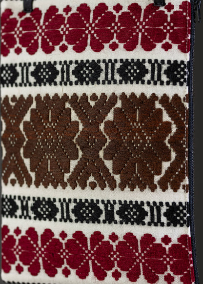 Close-up of the traditional motif on FTLO's handwoven clutch with earthy brown and red patterns.