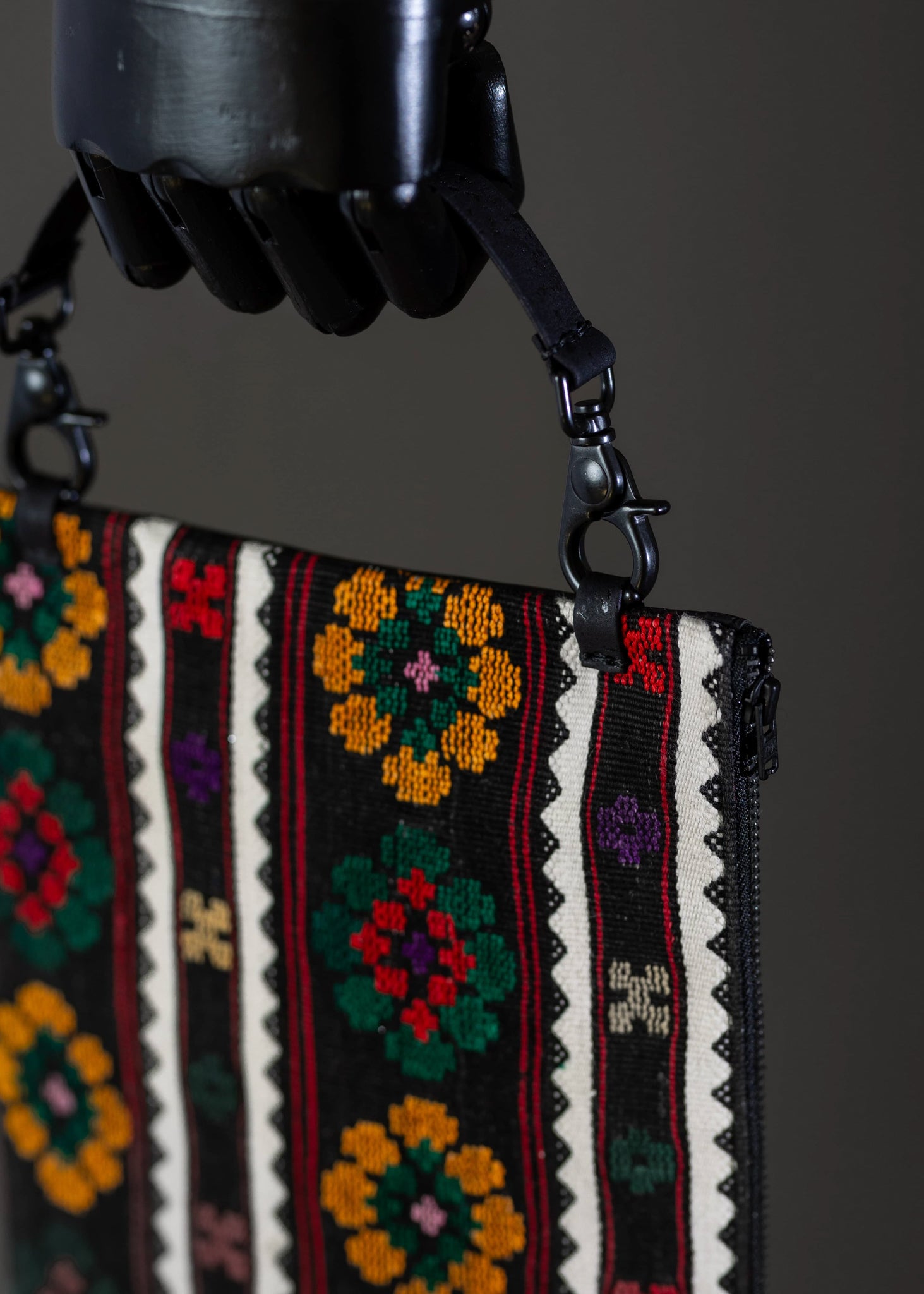 Close-up detail of FTLO clutch's colorful flower motifs, highlighting the diversity of embroidery hues.