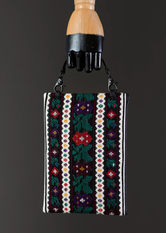 Front view of FTLO bag with a vivid garden palette of handwoven motifs.