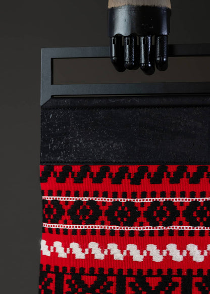 Detail shot of FTLO bag's traditional pattern with a dominant red background and contrasting black and white details.