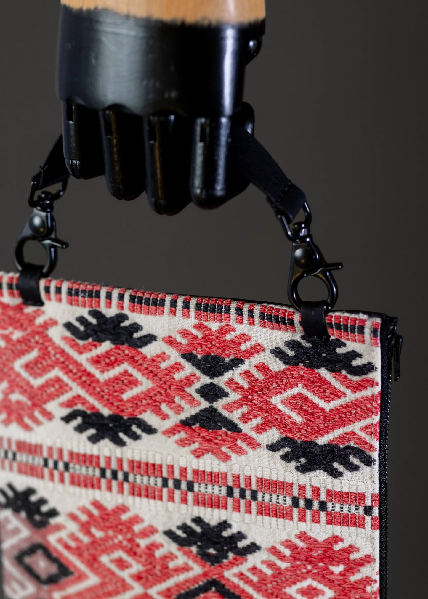 Detailed craftsmanship on FTLO red and black geometric patterned handwoven vintage bag.