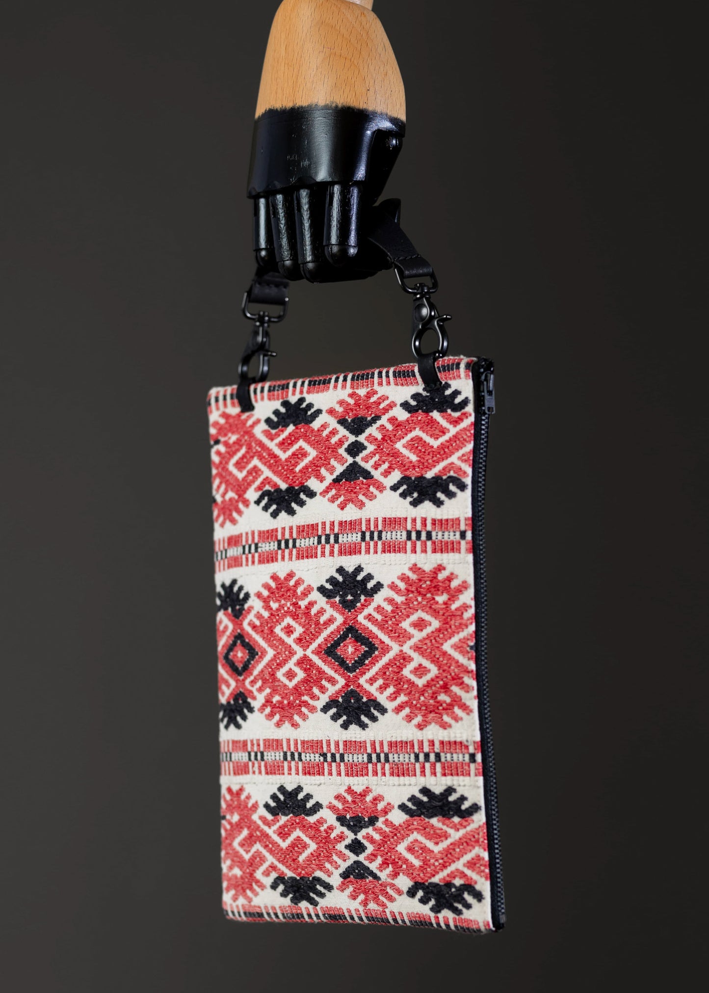 Side view of FTLO bag showcasing the intricate red and black geometric handwoven design.