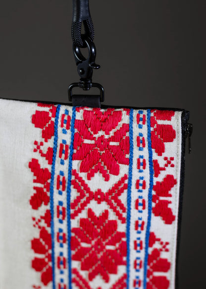 Close-up of FTLO small bag's red and blue geometric pattern and fabric texture.