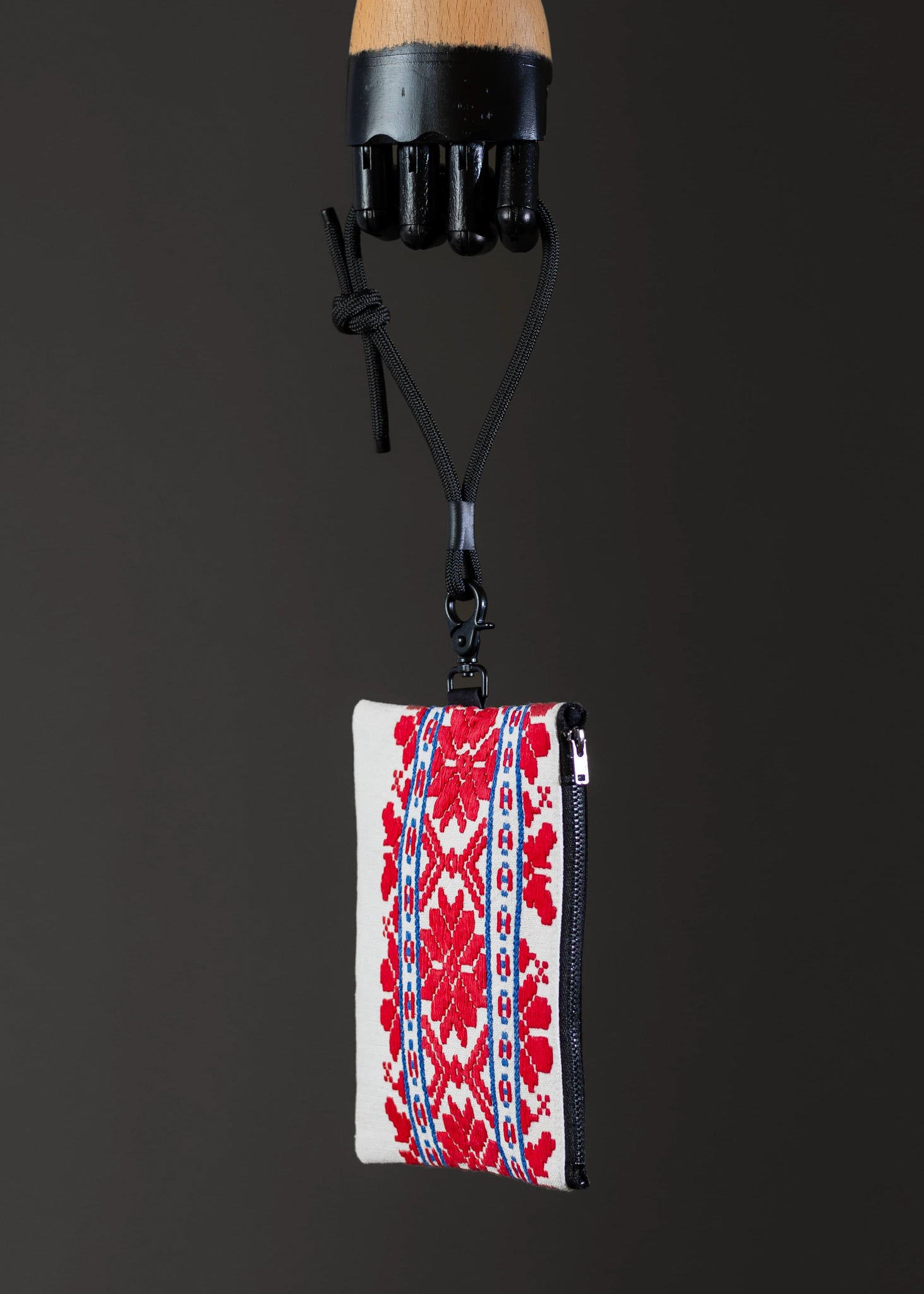 Side angle of FTLO small bag featuring intricate red and blue geometric design.