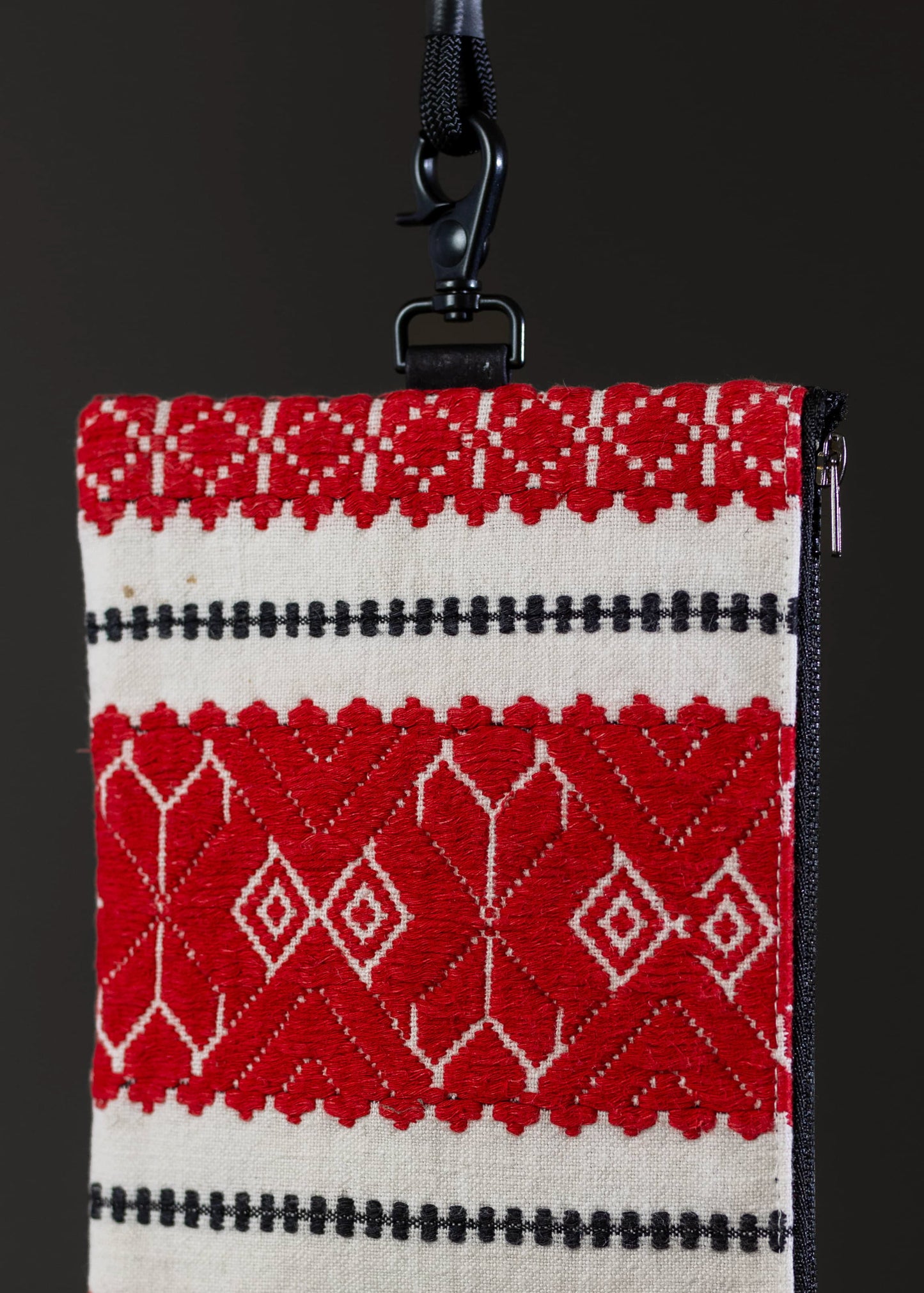 Detailed motif view of the FTLO small bag's red diamond weave pattern, showcasing the textile artistry.