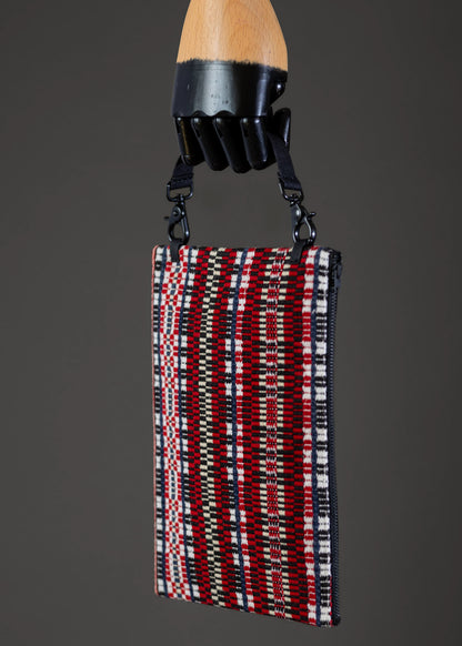 Side view of FTLO traditional red geometric clutch with detailed handwoven fabric.