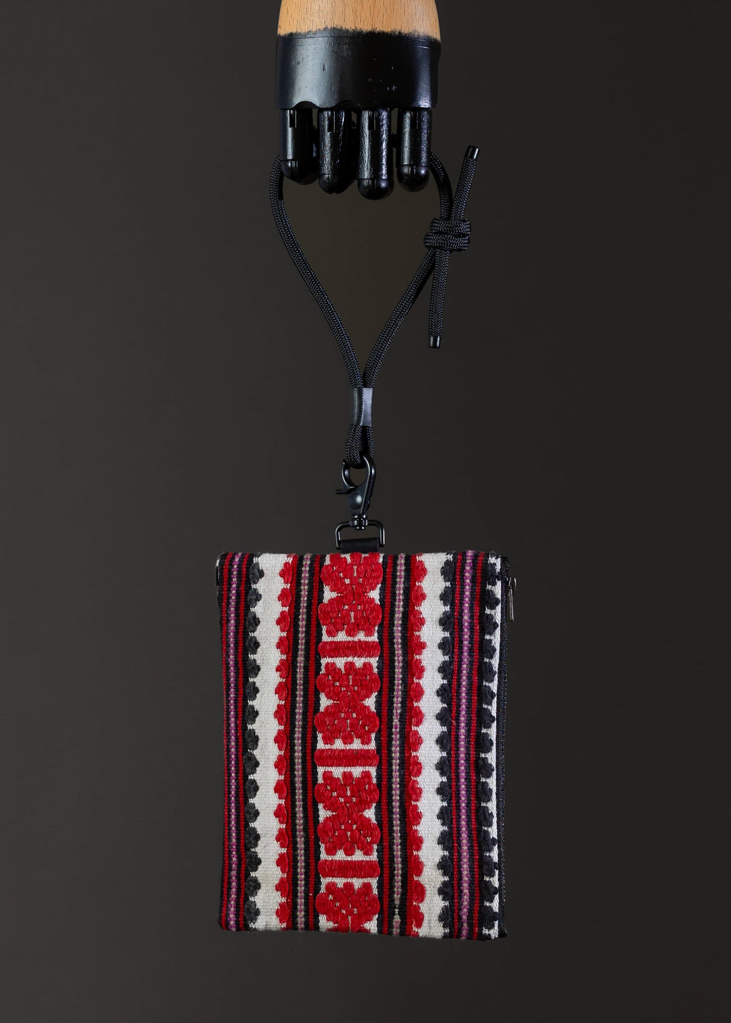 Front view of FTLO handwoven bag with red geometric patterns and stripes.