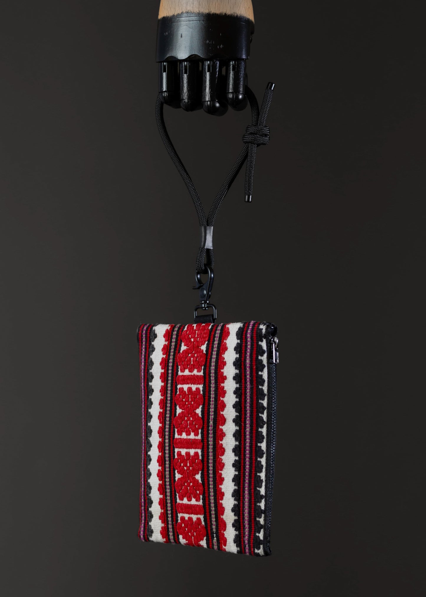 Side view of FTLO red and black geometric striped bag with artisanal weave.