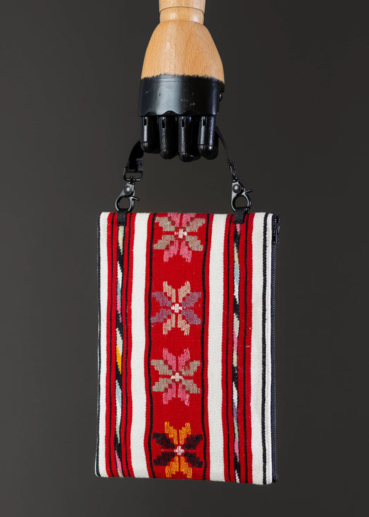 Front view of FTLO bag with red stripe and floral vintage Romanian handwoven design.