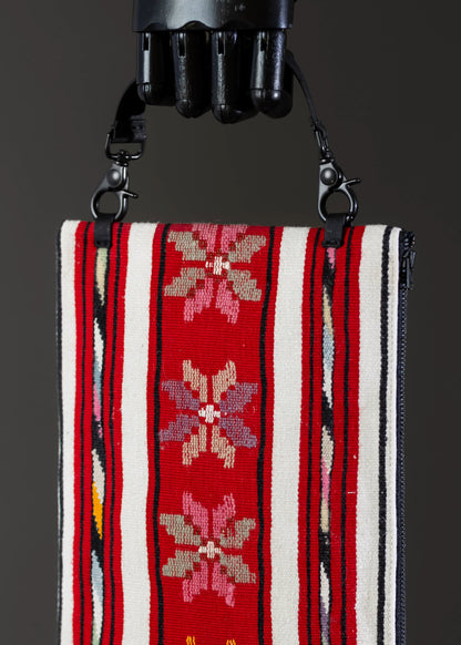 Close-up of the traditional floral motif on FTLO's red-striped vintage handwoven bag.