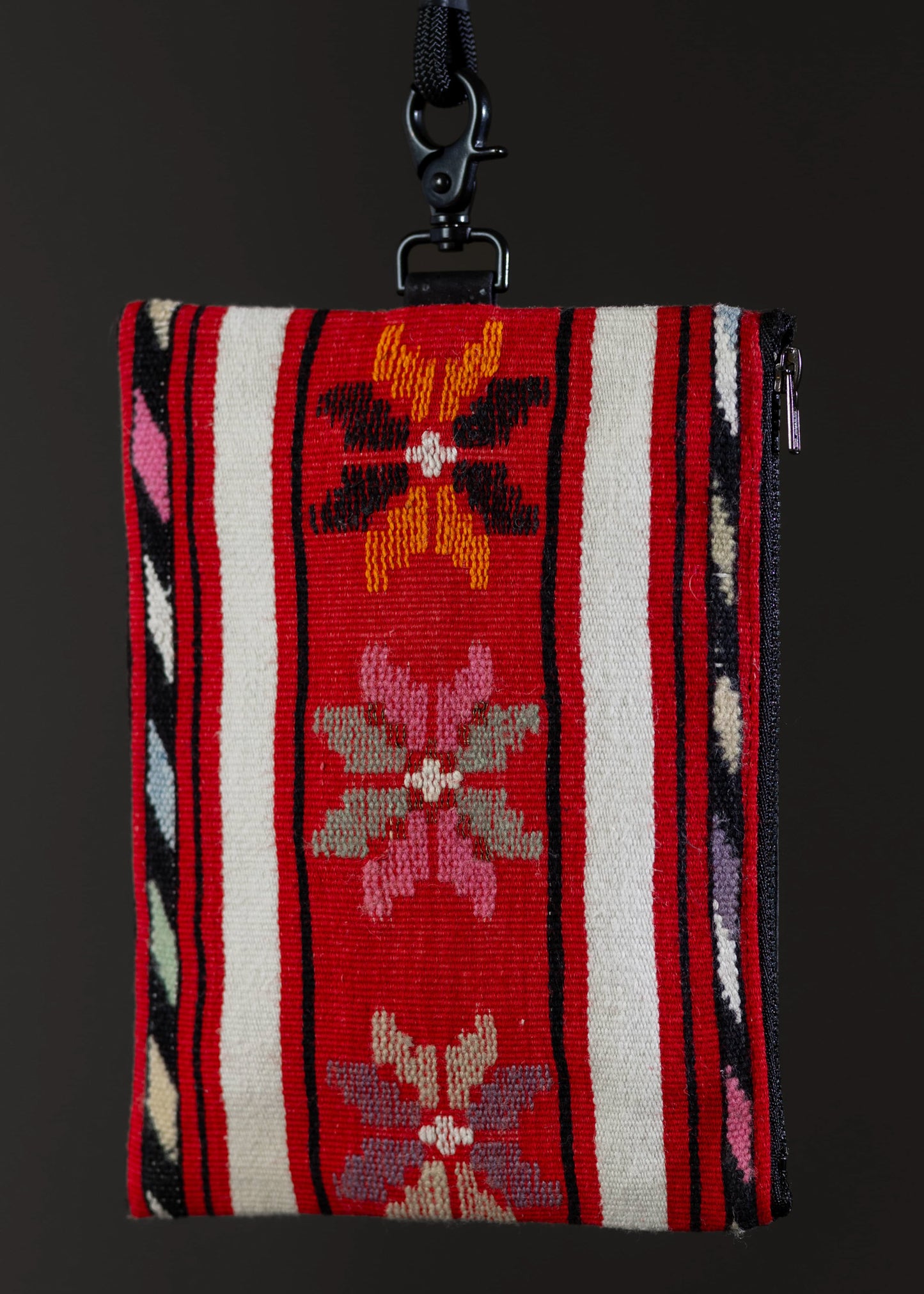 Close-up view of FTLO red and white striped bag with floral design.