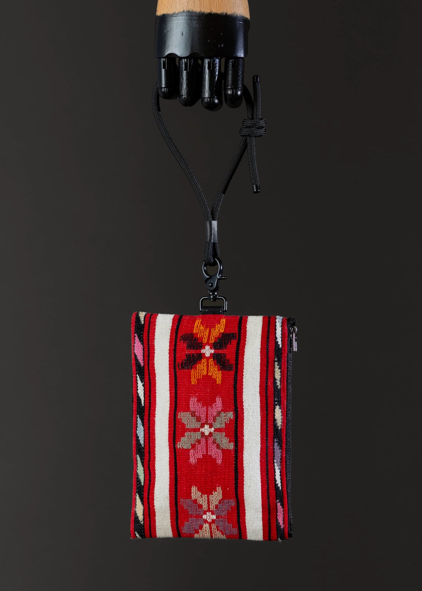 Front view of FTLO bag with red stripes and floral embroidery.