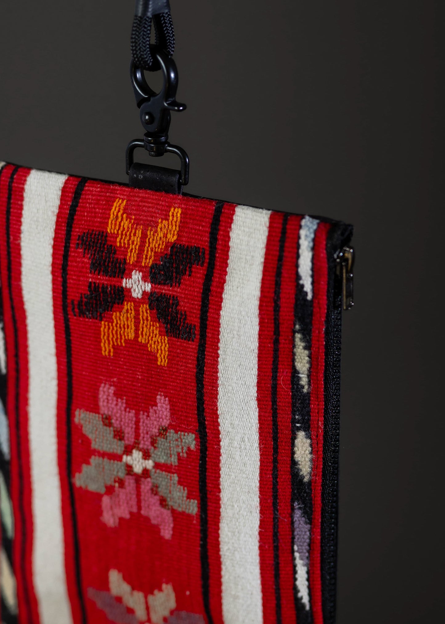 Detailed embroidery of flowers on FTLO red striped bag.