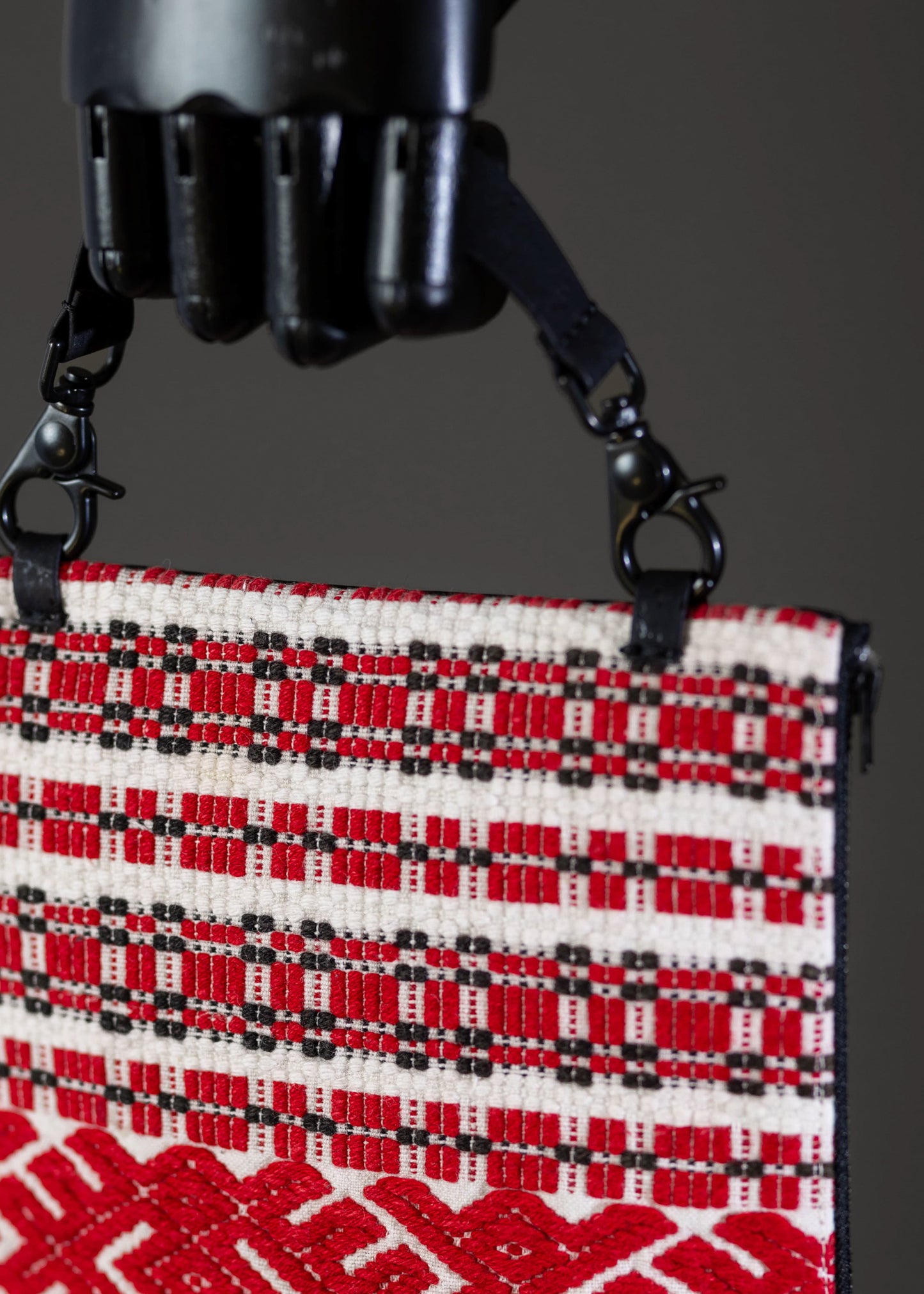 Detail view of FTLO bag's red geometric embroidery highlighting Romanian artisanal work.