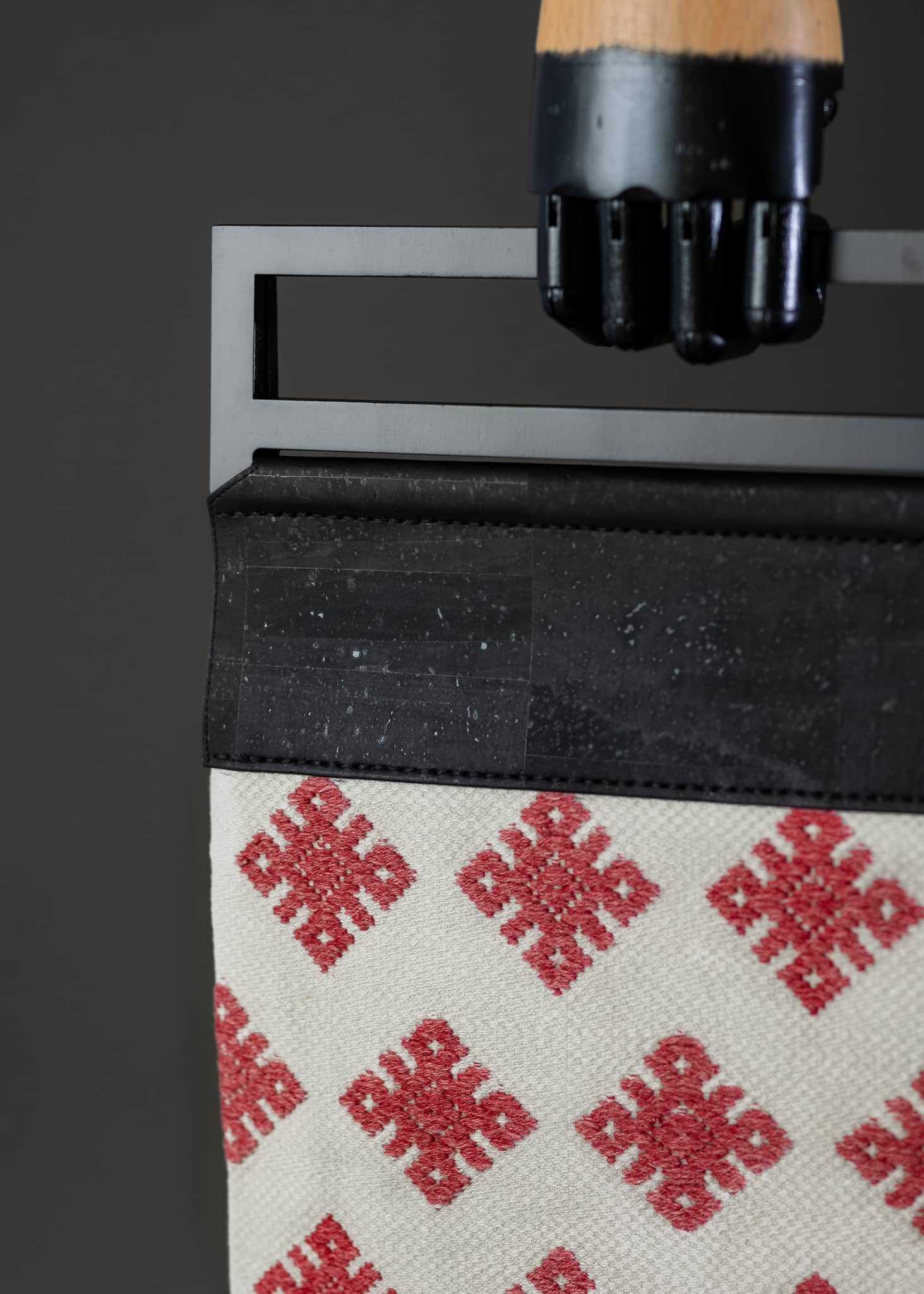 Close-up detail of FTLO bag highlighting the intricate diamond weave and vibrant red against a clean white background.