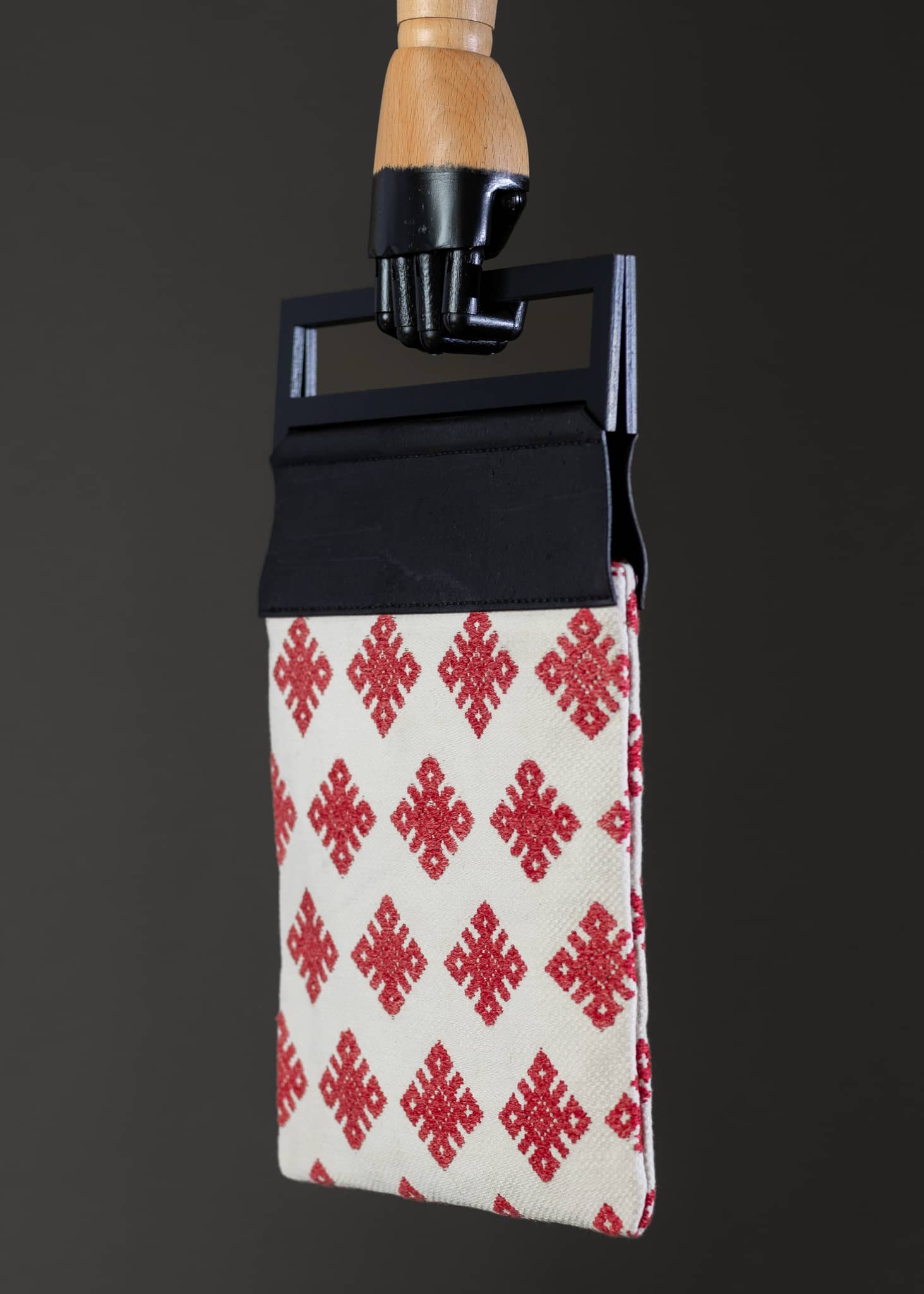 Side perspective of FTLO red and white diamond-patterned bag, showcasing the design's continuity and strap attachment.