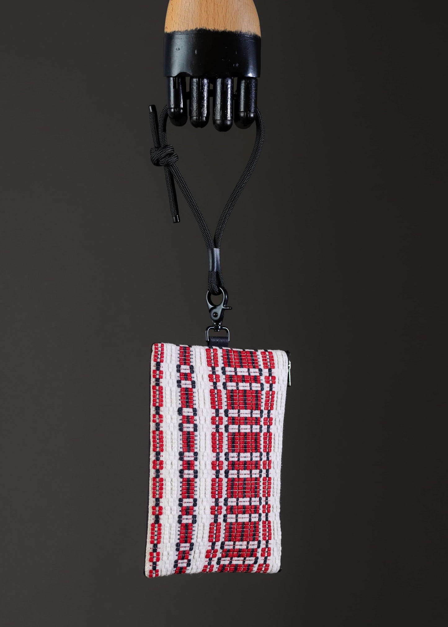 Side view of FTLO small handwoven bag with red and white pattern.