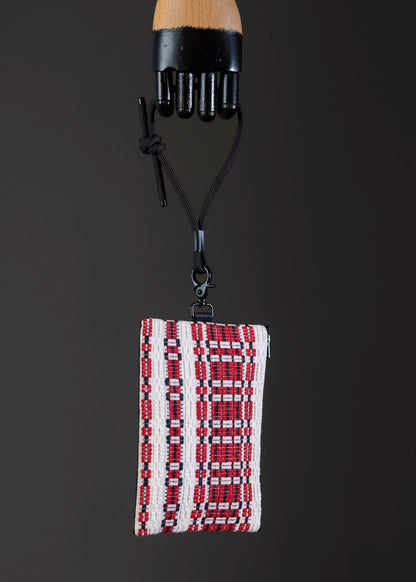 Side view of FTLO small handwoven bag with red and white pattern.