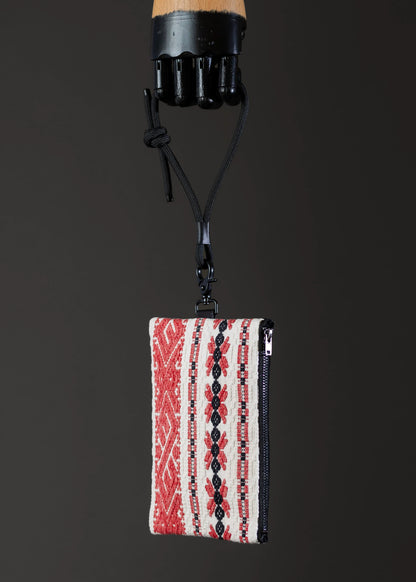 Side view of the small FTLO bag with red and black stripes and intricate designs.