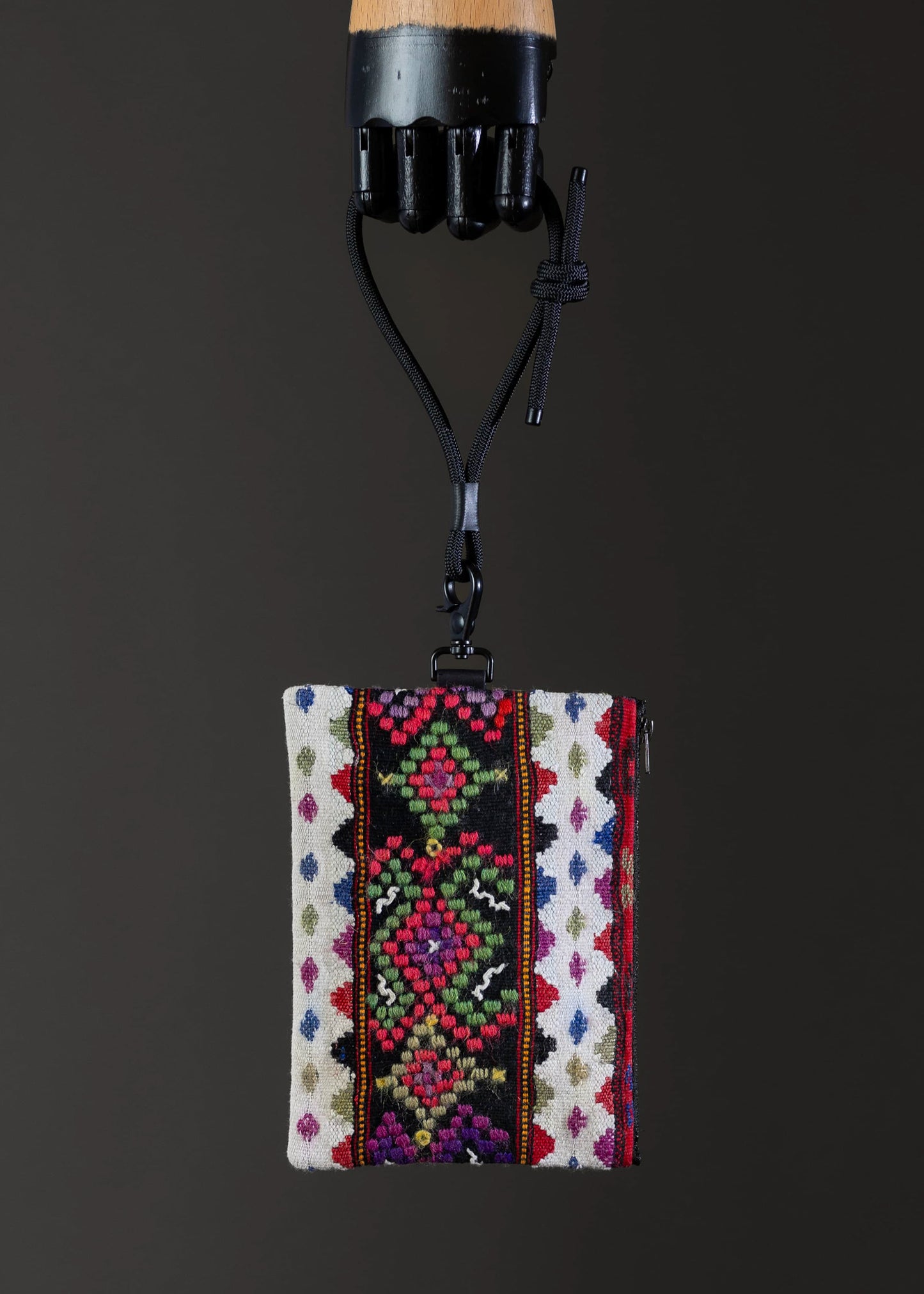 Front view of the small FTLO bag with vibrant geometric patterns.