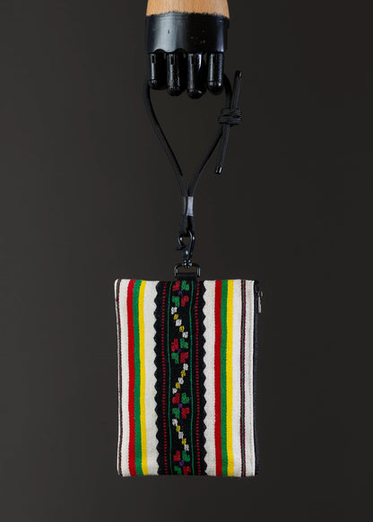 Front view of FTLO striped multicolor bag showcasing vibrant traditional weaving.