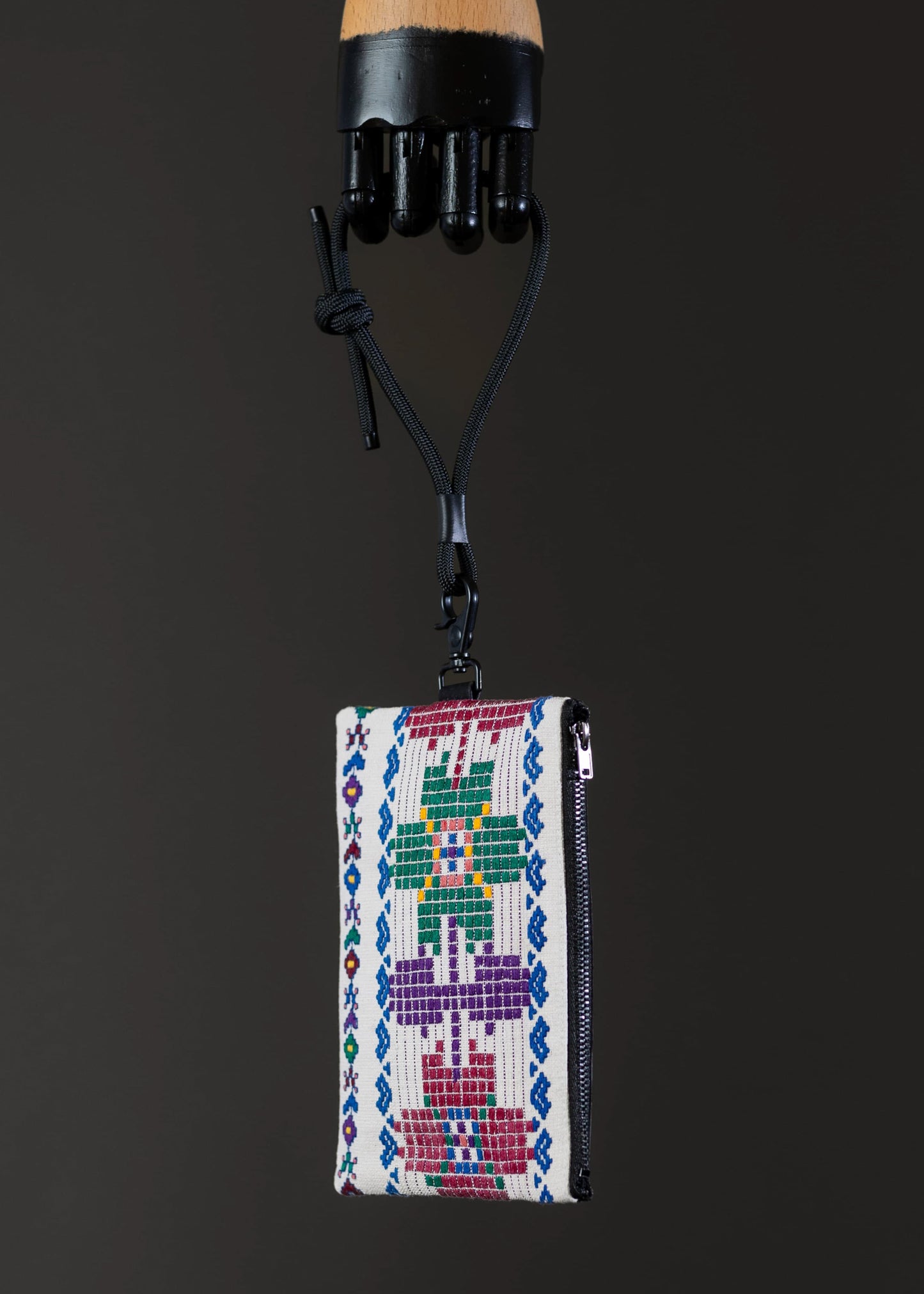 Side view of FTLO's artisanal woven bag highlighting the textile's texture and hues.