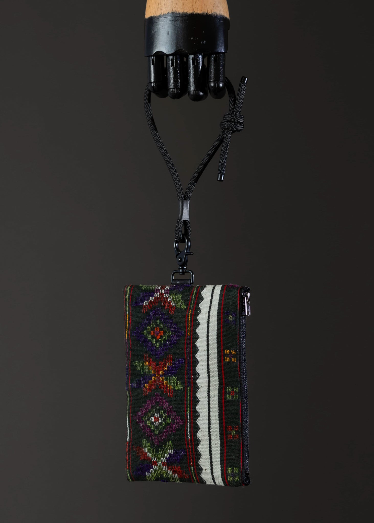 Side view of the small FTLO bag with colorful, detailed stitching and design.